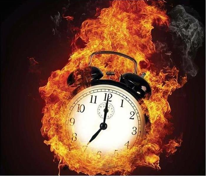 Alarm clock with flames around it.