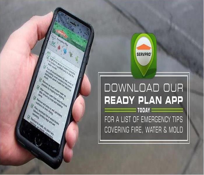 Hand holding a mobile phone with the SERVPRO Ready plan APP