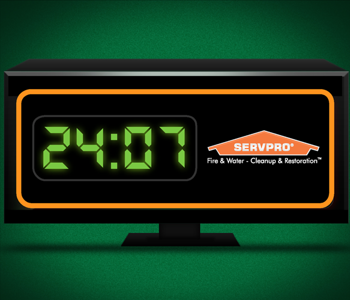 Green alarm clock with numerals twenty-four and 7.
